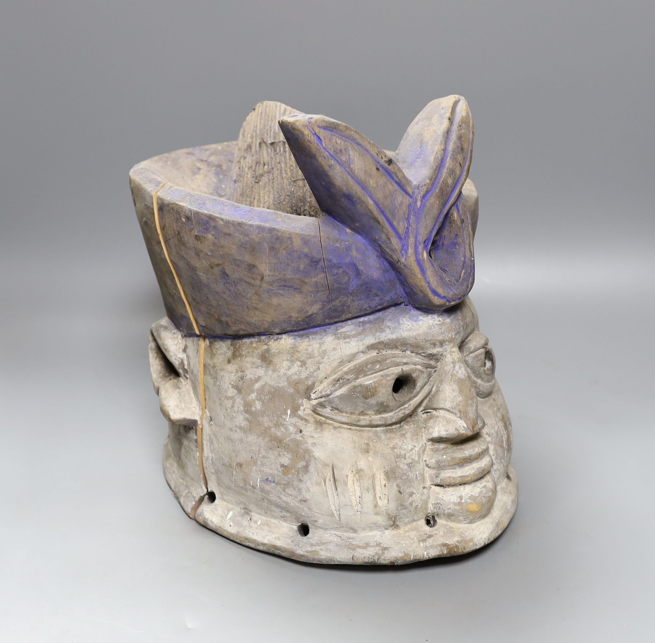 A Nigerian carved wood tribal mask, 30 cms high.